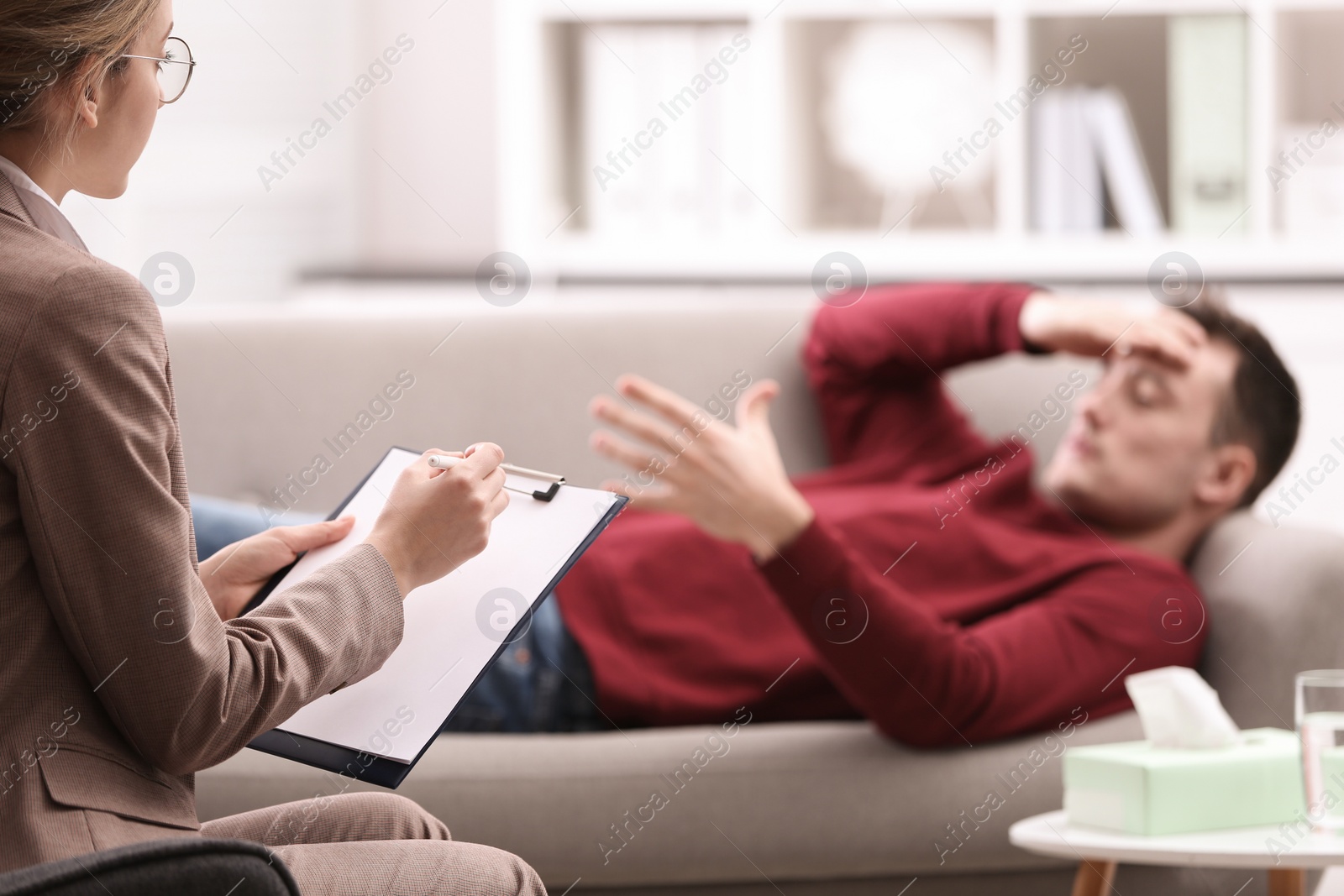 Photo of Psychotherapist working with young man in office