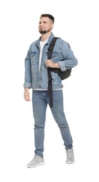 Man with backpack in denim clothes walking on white background