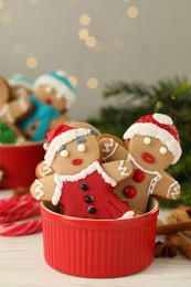 Photo of Delicious homemade Christmas cookies on white wooden table against blurred festive lights