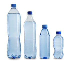 Photo of Row of different plastic bottles with water on white background