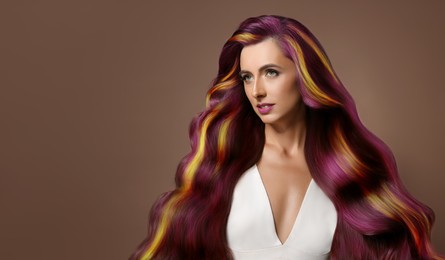 Hair styling. Attractive woman with colorful hair on pale brown background. Banner design with space for text