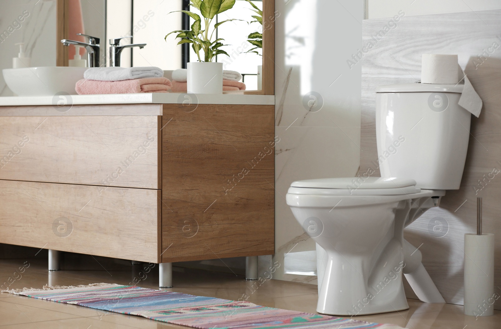 Photo of Interior of modern bathroom with toilet bowl