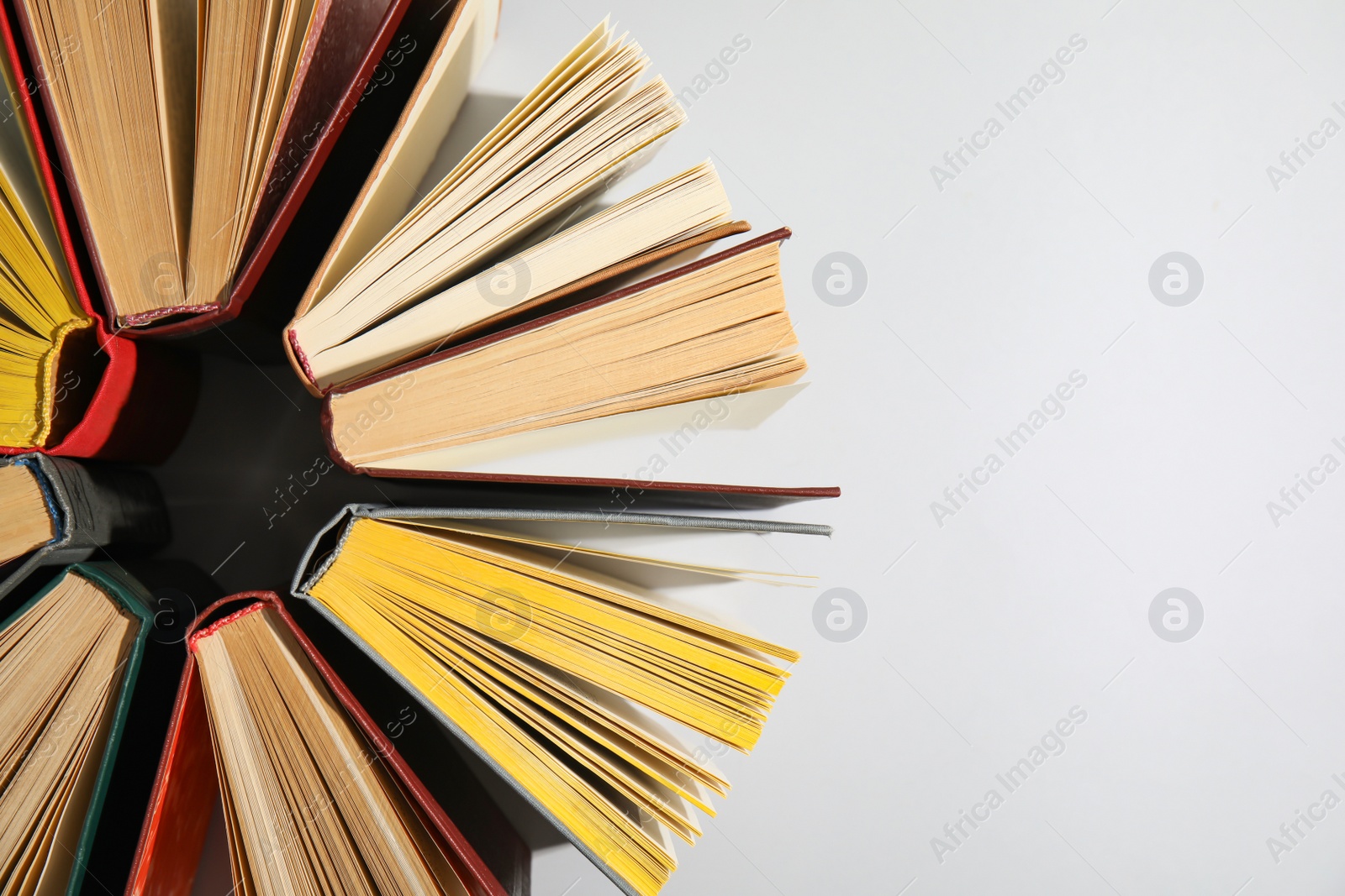 Photo of Circle made of hardcover books on grey background, flat lay