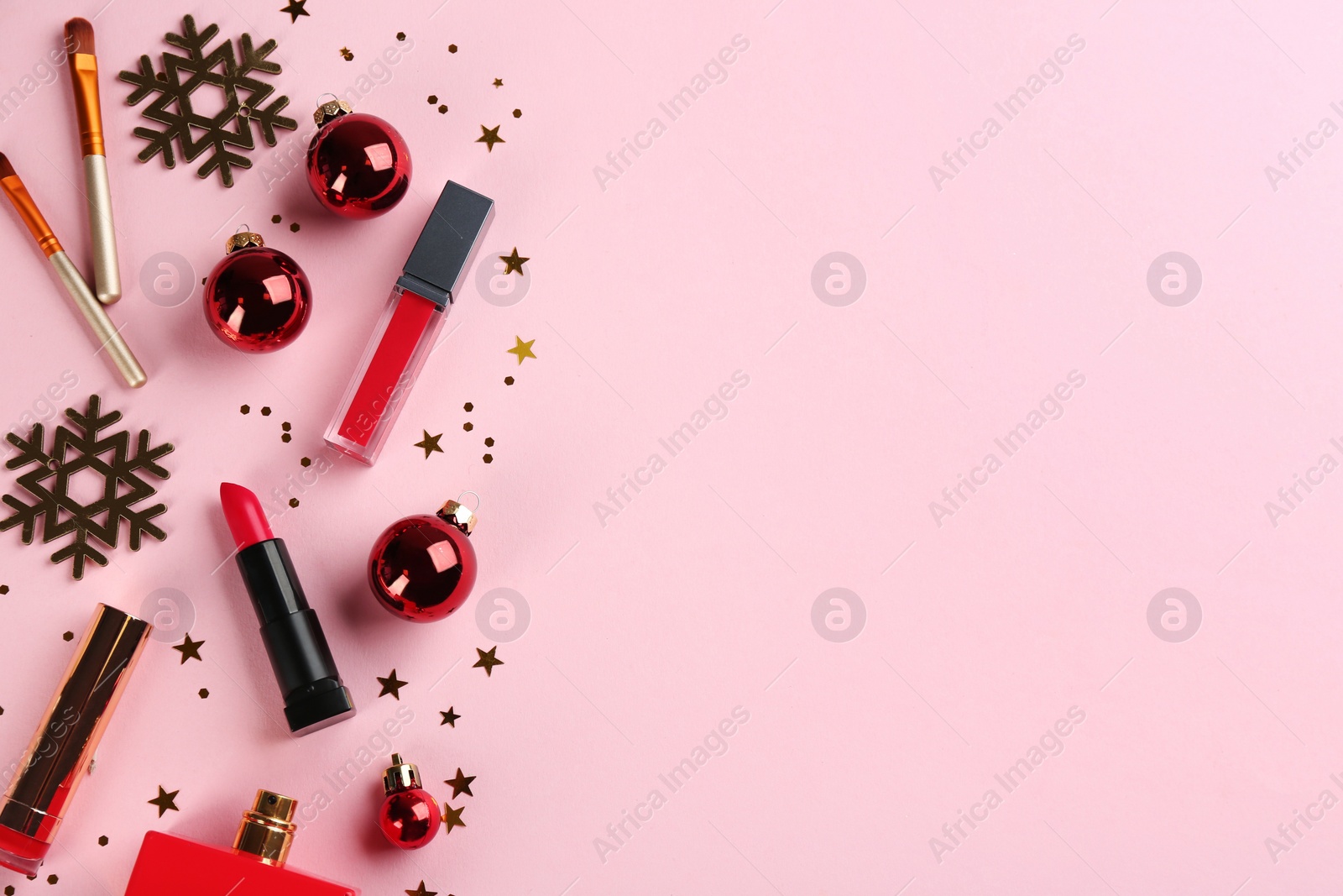 Photo of Flat lay composition with decorative cosmetic products on pink background, space for text. Winter care