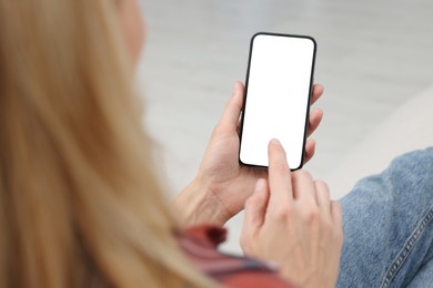 Photo of Woman using smartphone at home, closeup. Space for text