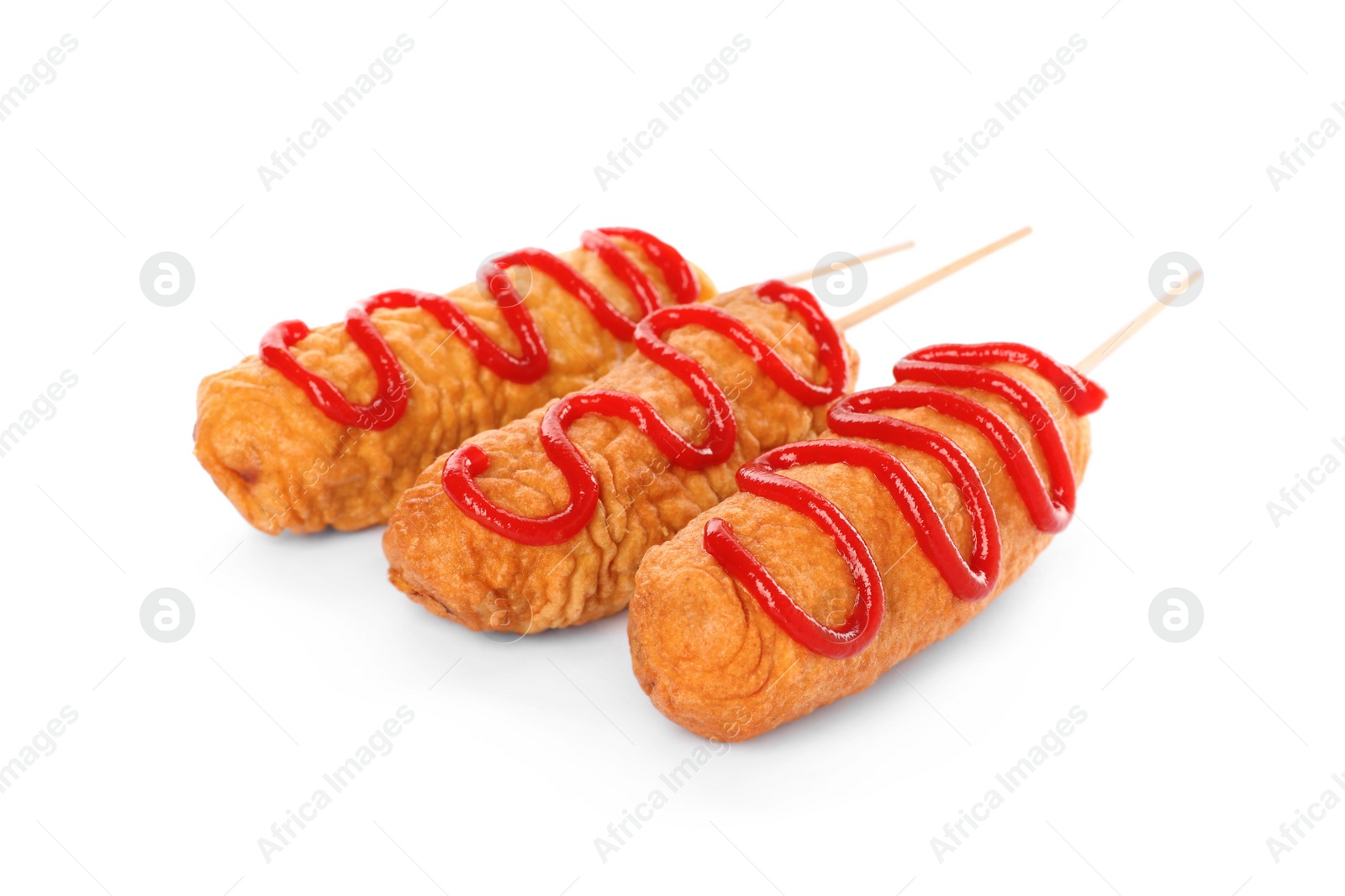 Photo of Delicious deep fried corn dogs with ketchup on white background