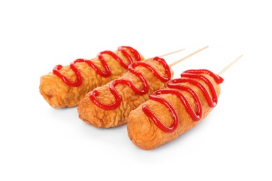 Delicious deep fried corn dogs with ketchup on white background
