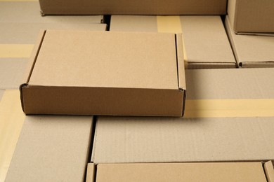 Photo of Many cardboard boxes as background, closeup. Packaging goods