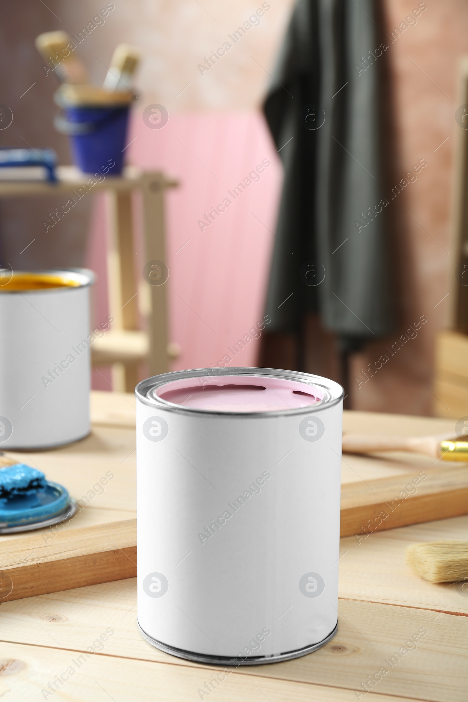 Photo of Can of paint on wooden table indoors