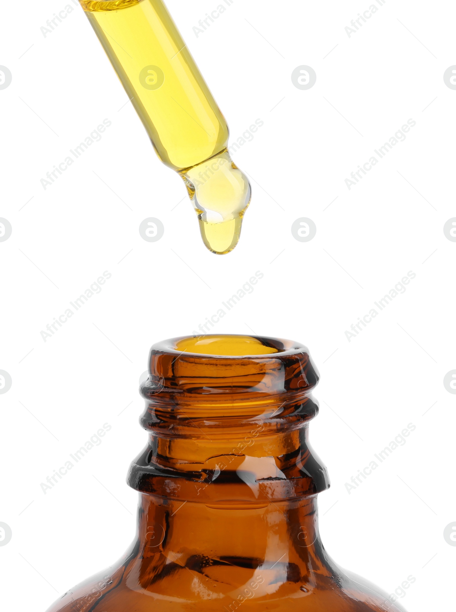 Photo of Dripping tincture from pipette into bottle isolated on white