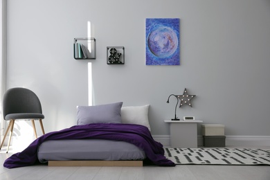Modern teenager's room interior with comfortable bed and stylish design elements