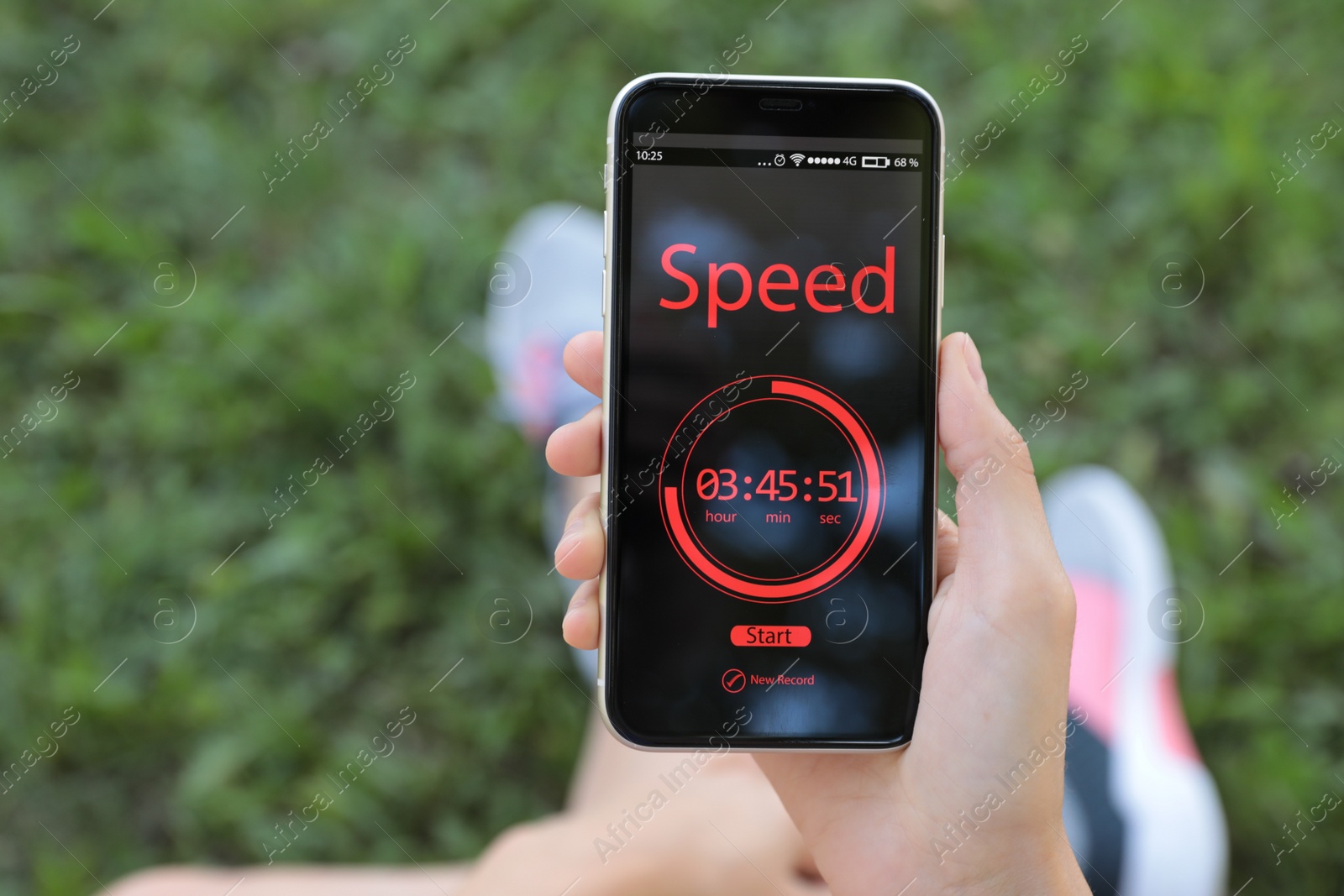 Photo of Young woman using fitness app on smartphone outdoors, closeup