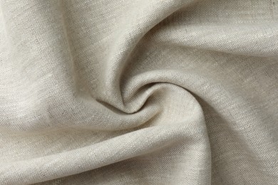 Texture of beige crumpled fabric as background, top view