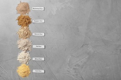 Photo of Composition with different types of flour on light background