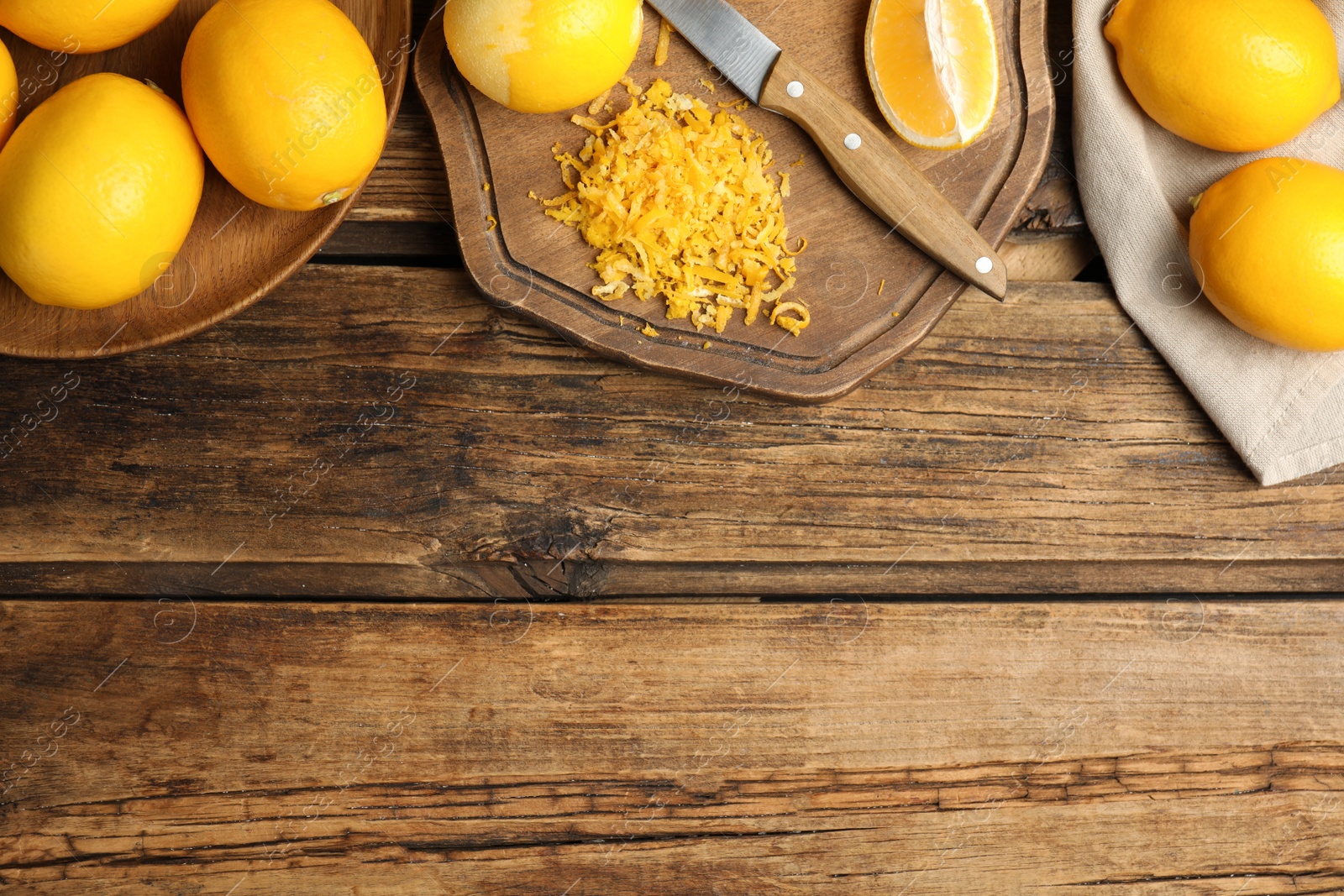 Photo of Lemon zest and fresh fruits on wooden table, flat lay. Space for text