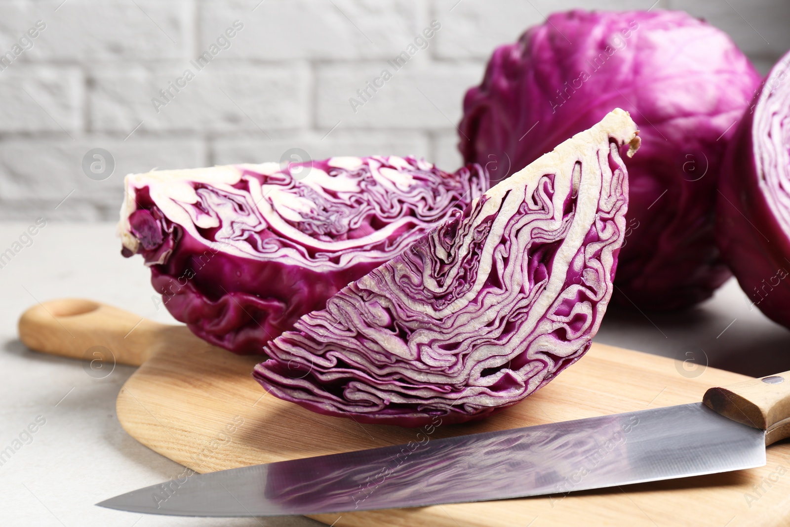 Photo of Fresh ripe red cabbages on table, closeup