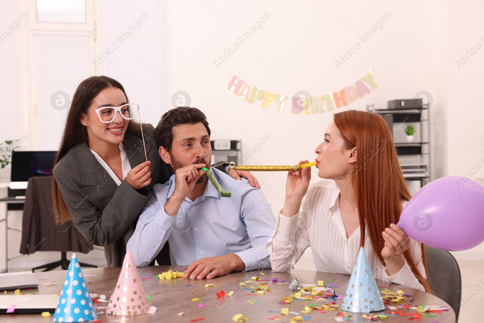 Photo of Coworkers having fun during office party indoors