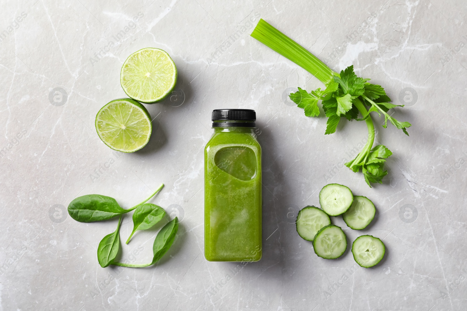 Photo of Flat lay composition with bottle of delicious detox juice and ingredients on light background