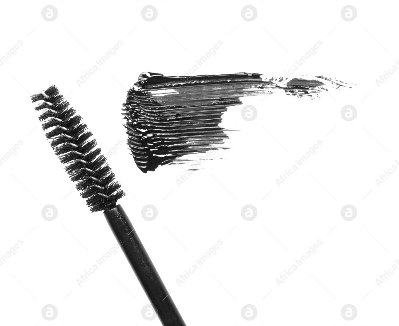 Photo of Smear of mascara and applicator isolated on white, top view