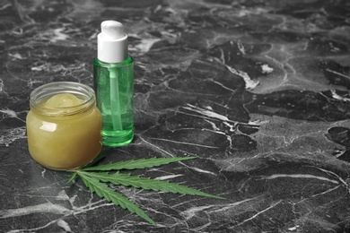 Photo of Composition with hemp lotion and space for text on marble background