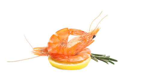 Photo of Delicious cooked shrimps, lemon and rosemary isolated on white