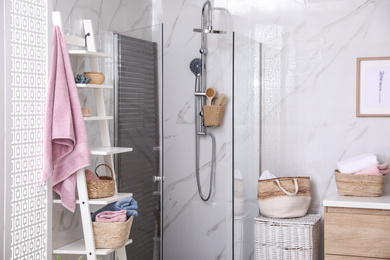 Bathroom interior with shower stall and shelving unit. Idea for design