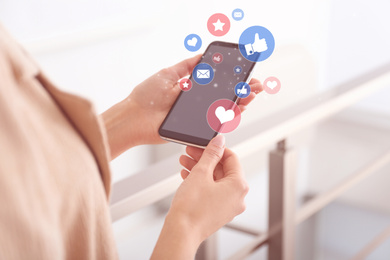 Image of Young woman using modern smartphone indoors, closeup