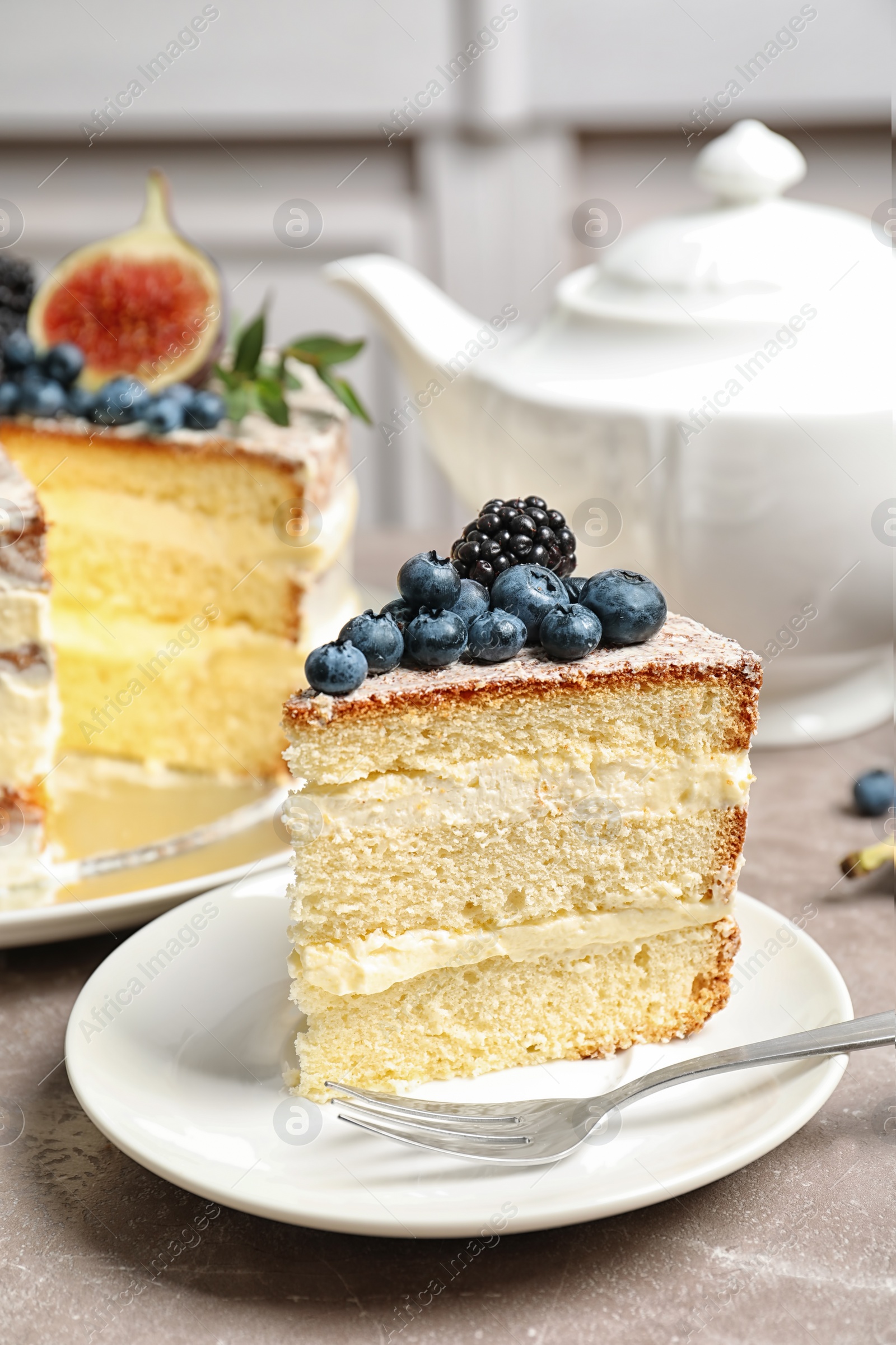 Photo of Piece of delicious homemade cake with fresh berries served on table