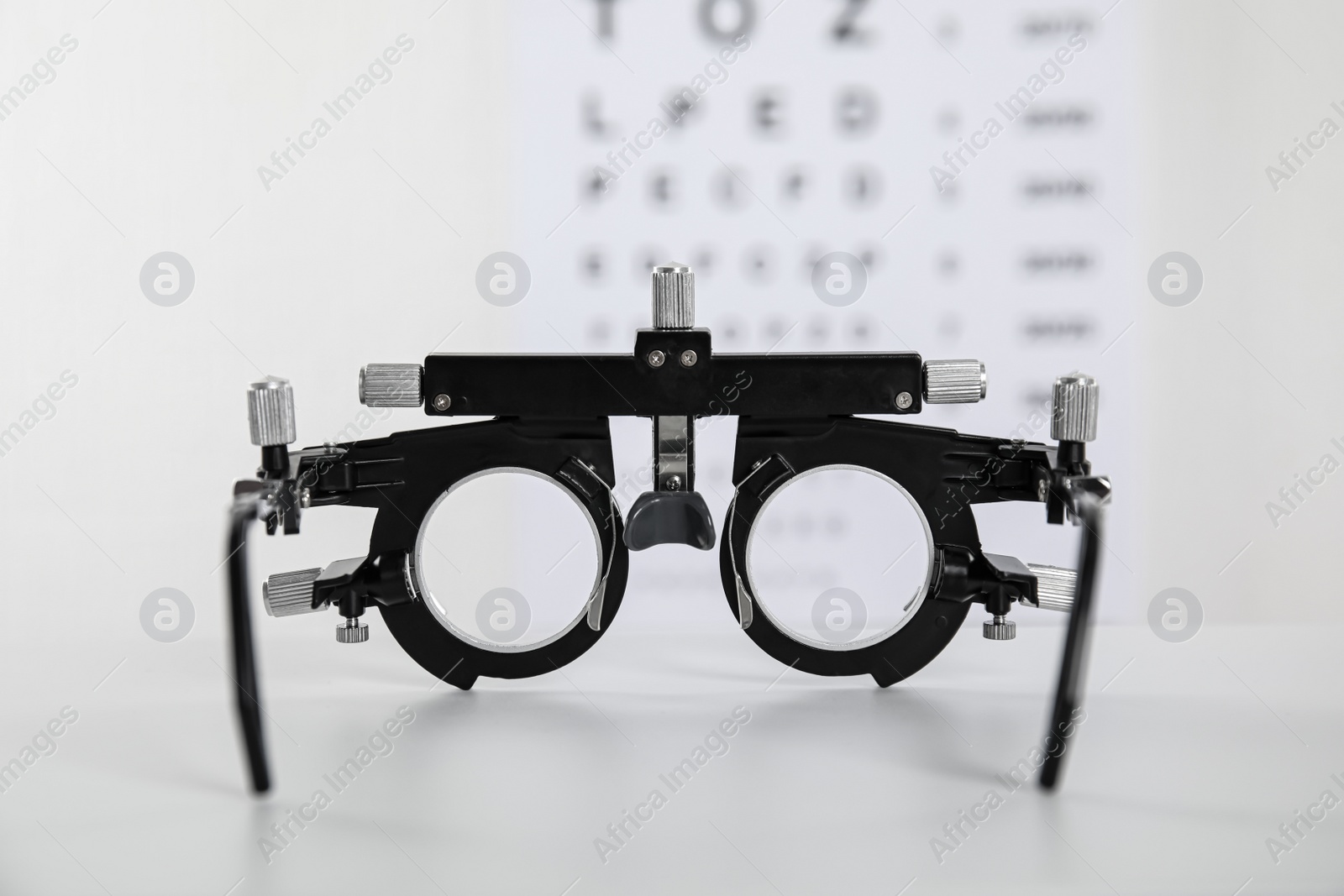 Photo of Trial frame on light background, closeup. Ophthalmologist tool