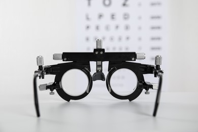 Photo of Trial frame on light background, closeup. Ophthalmologist tool