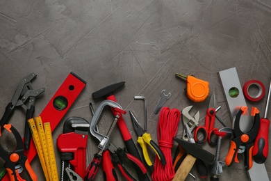 Photo of Flat lay composition with repair tools on grey stone table, space for text