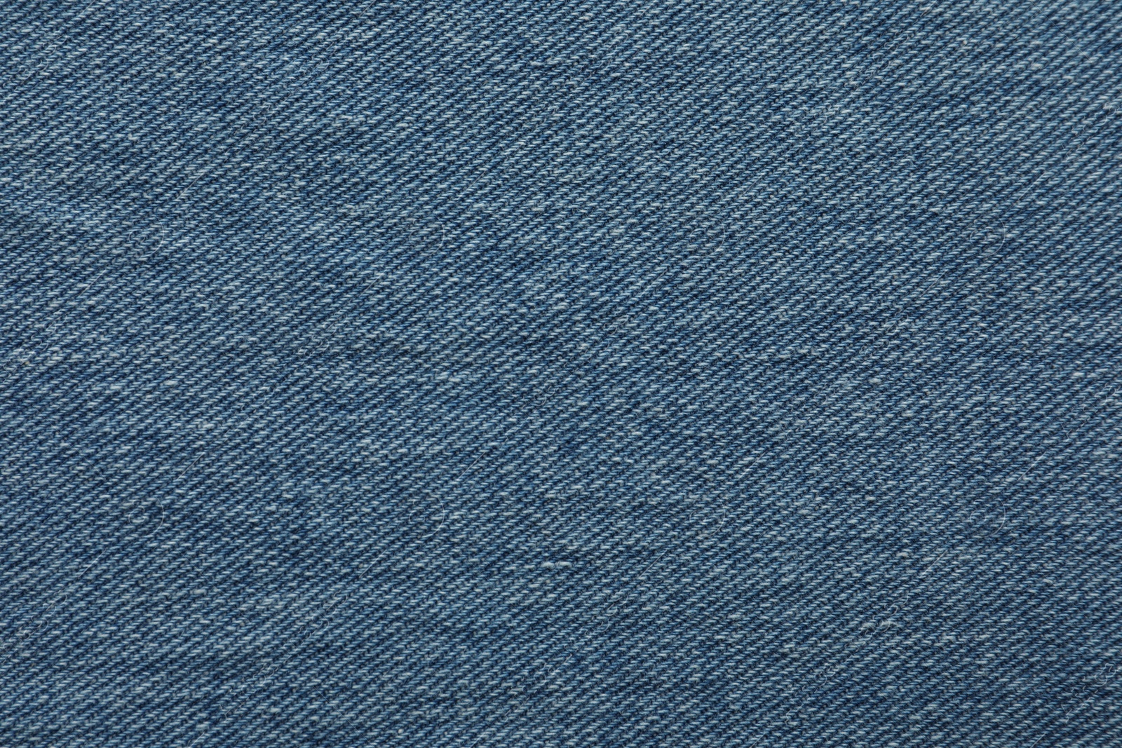 Photo of Texture of blue jeans as background, closeup