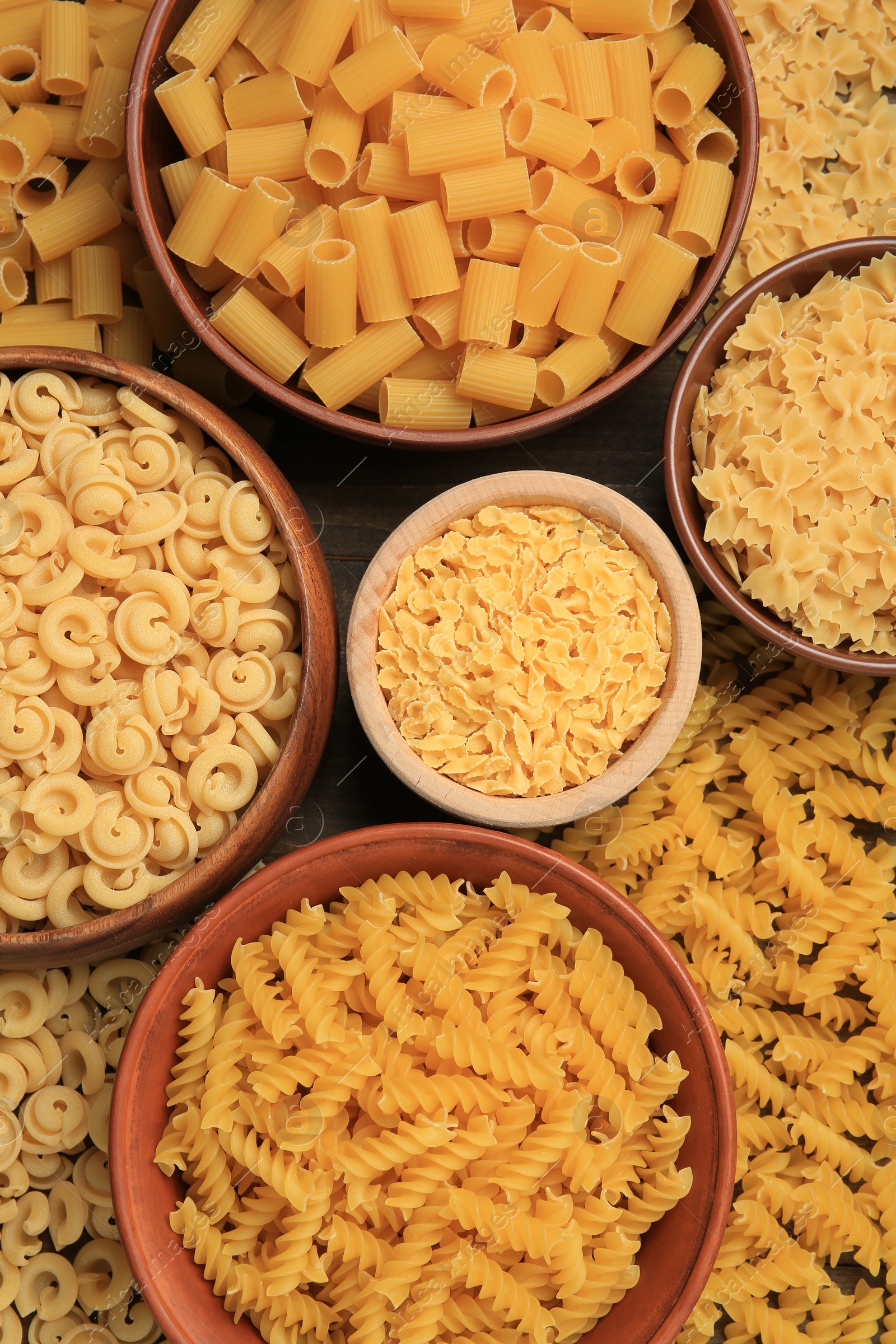 Photo of Different types of pasta on table, flat lay