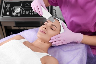 Young woman undergoing cosmetic procedure in beauty salon. Microcurrent therapy