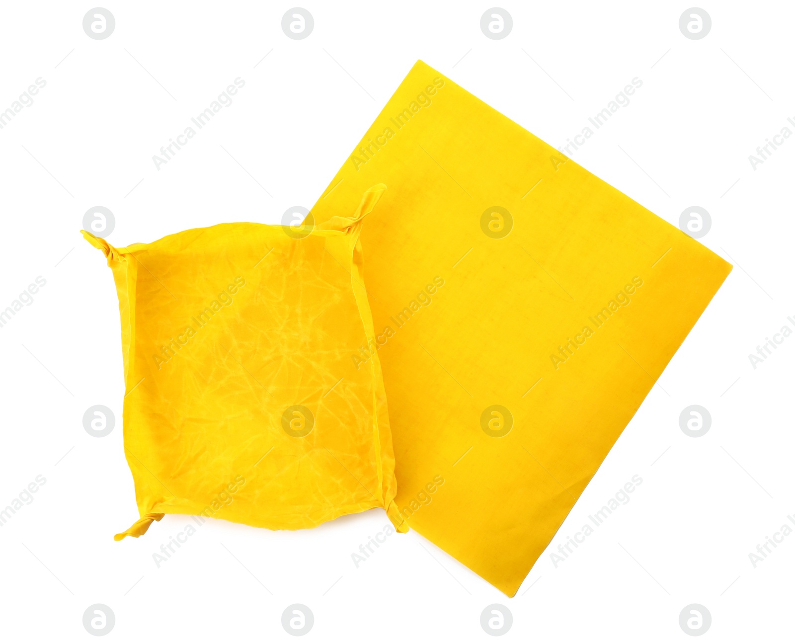 Photo of Yellow beeswax food wraps on white background, top view