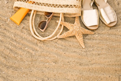 Photo of Composition with beach accessories on sand, top view. Space for text
