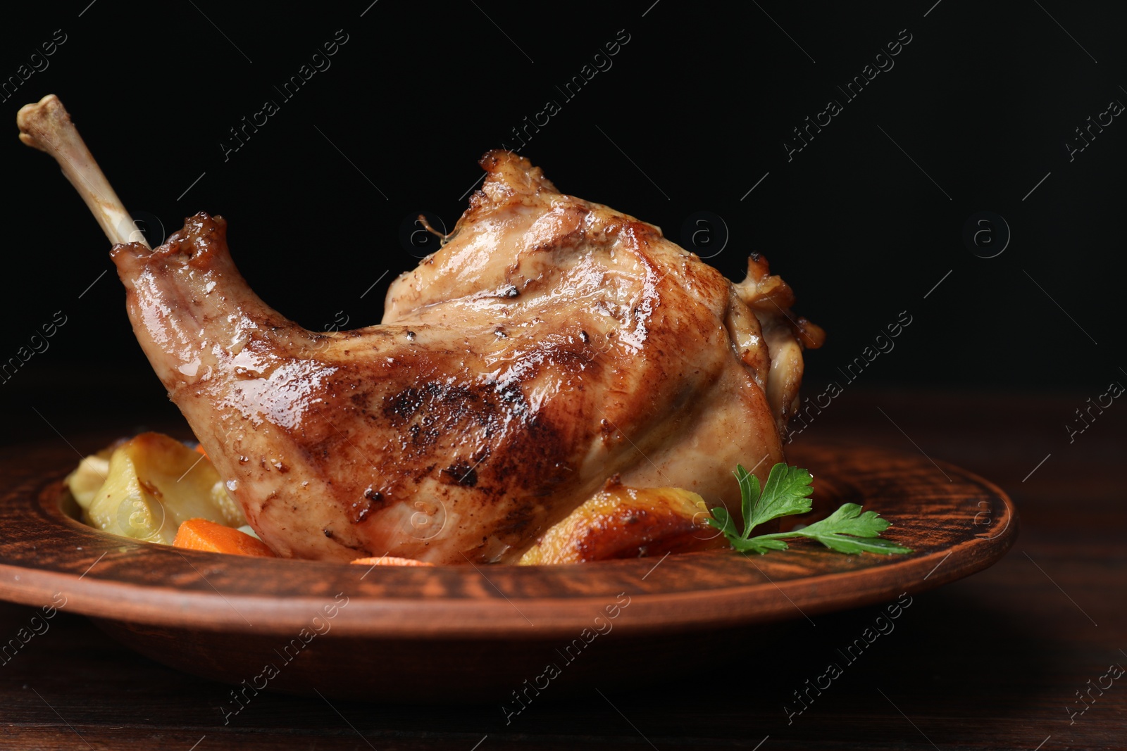 Photo of Tasty cooked rabbit meat with potatoes on table, closeup