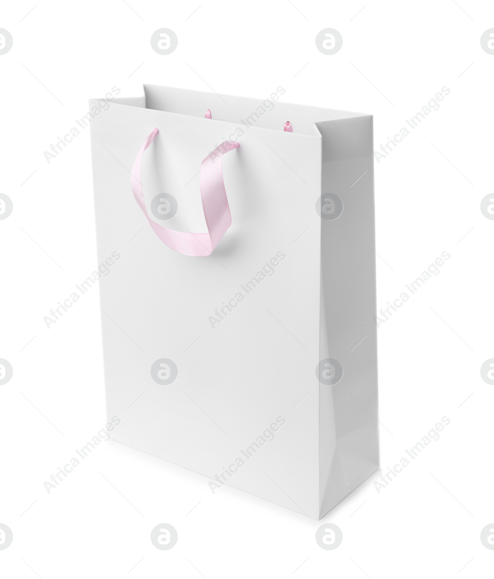 Photo of Paper shopping bag with ribbon handles on white background. Mockup for design