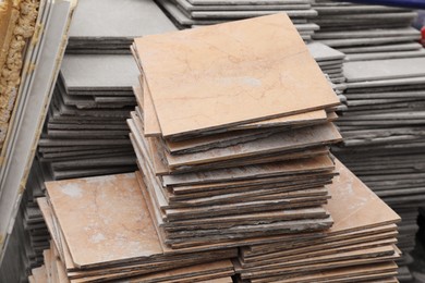 Photo of Stacks of ceramic tiles as background, closeup