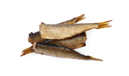 Many tasty smoked sprats isolated on white, top view