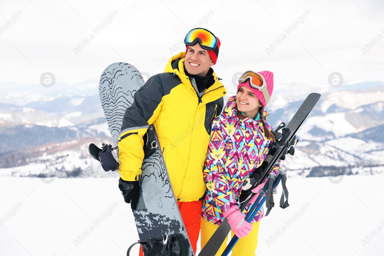 Photo of Lovely couple with equipment at ski resort. Winter vacation