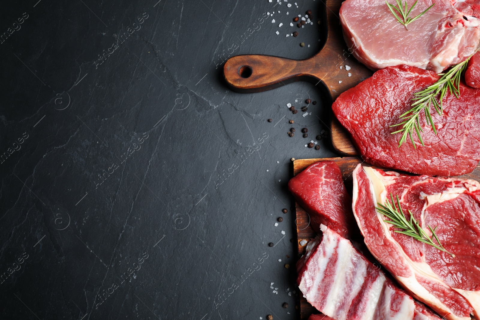 Photo of Flat lay composition with fresh meat on grey table. Space for text