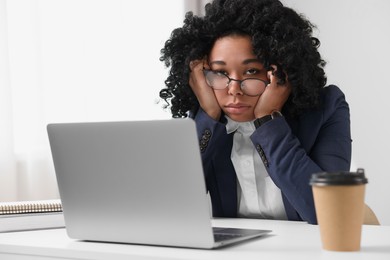 Photo of Deadline concept. Tired woman sitting near laptop in office