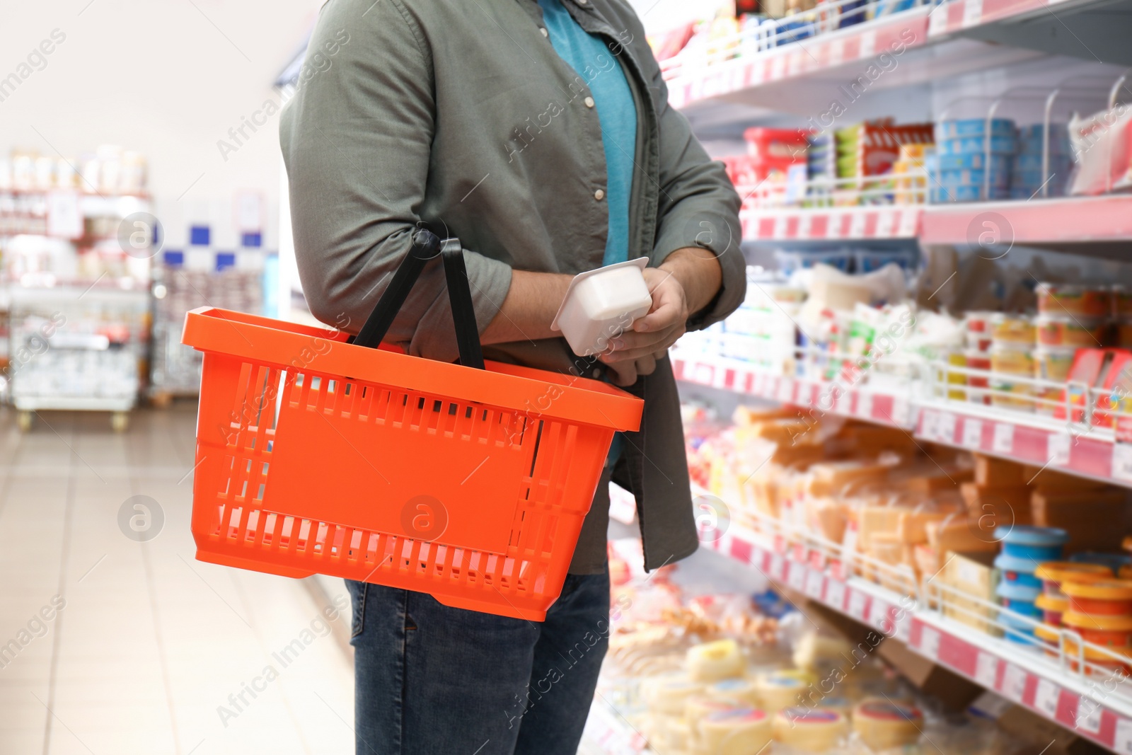 Photo of Man with shopping basket in supermarket, closeup