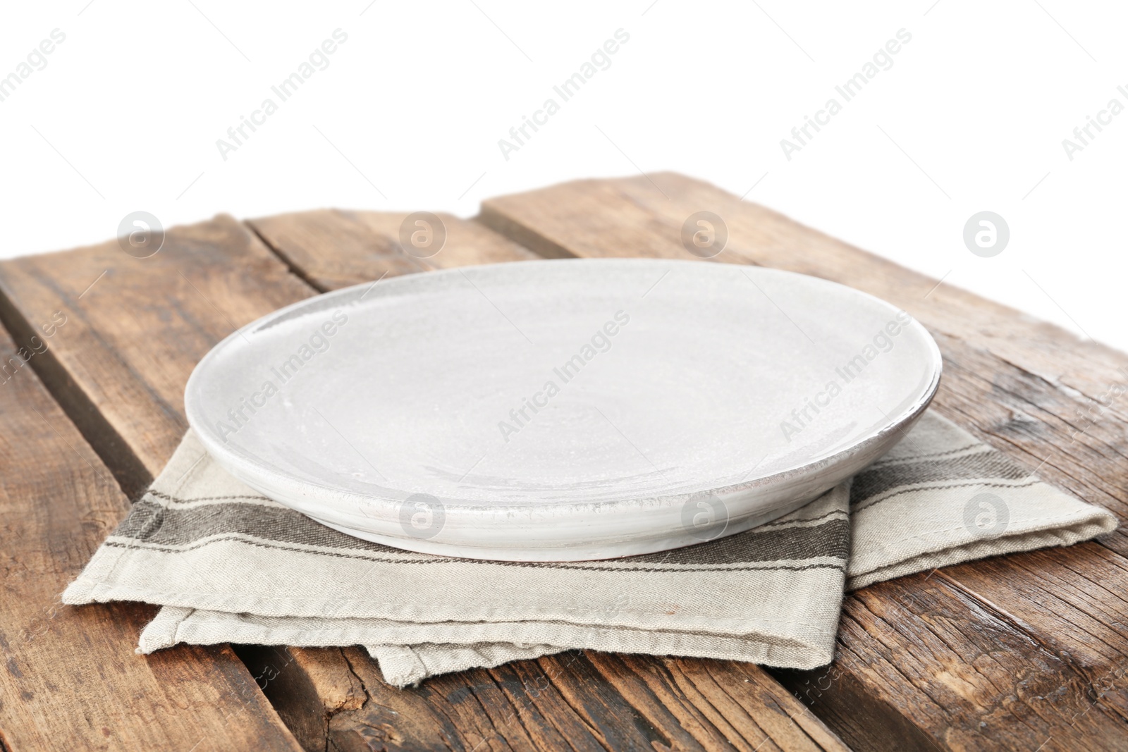 Photo of Empty plate and napkin on wooden table against white background