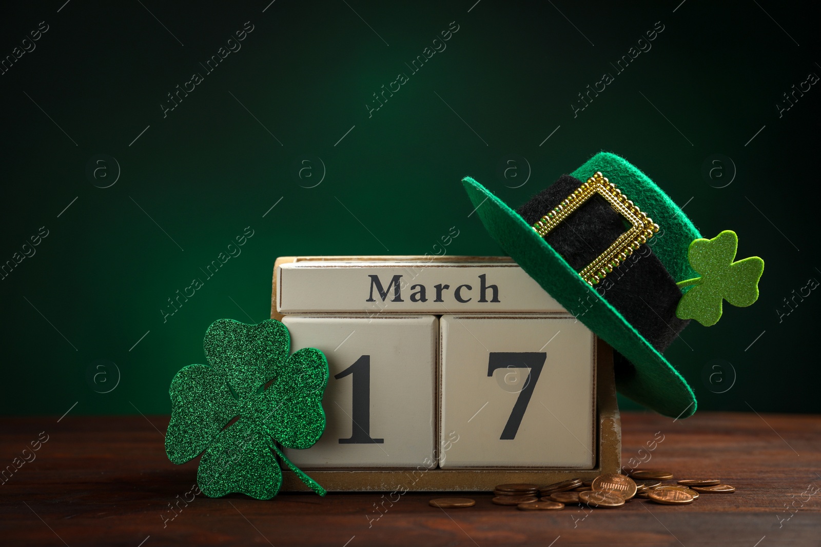 Photo of Composition with block calendar on wooden table. St. Patrick's Day celebration