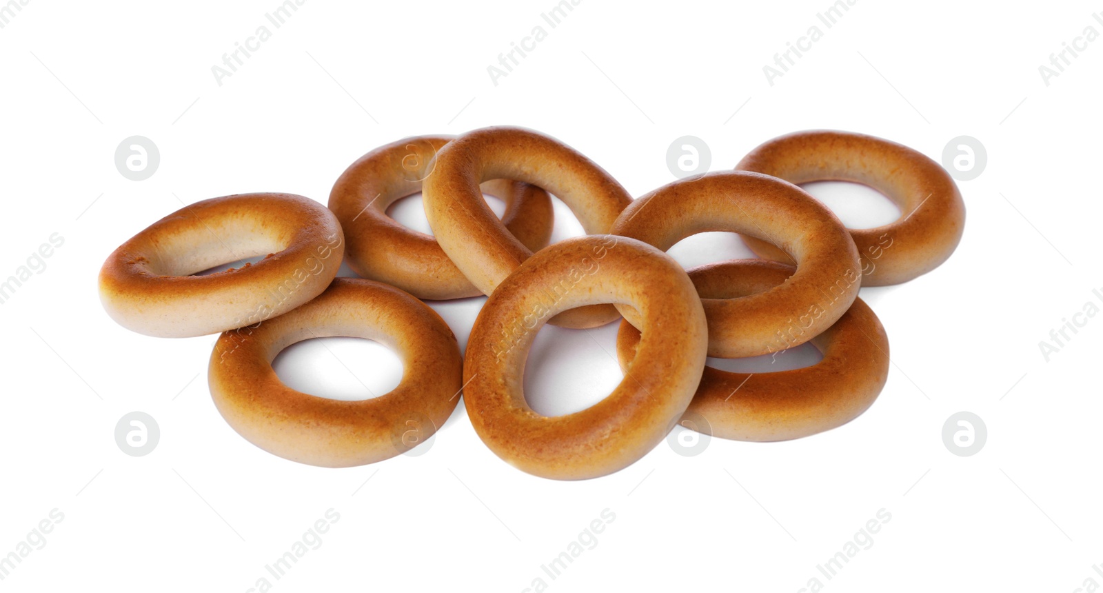 Photo of Many tasty dry bagels (sushki) isolated on white