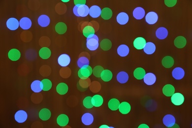 Photo of Blurred view of glowing Christmas lights as background