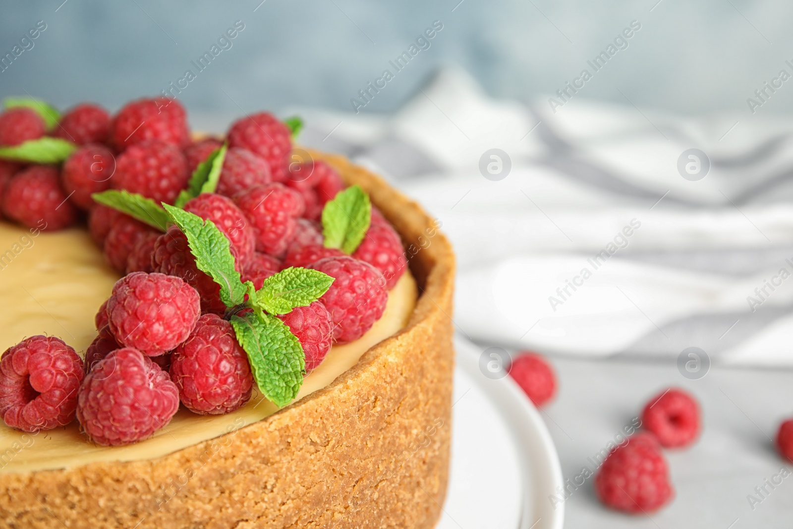 Photo of Delicious raspberry cake on table, closeup. Space for text