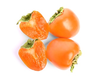 Photo of Delicious cut and whole fresh persimmons isolated on white, top view